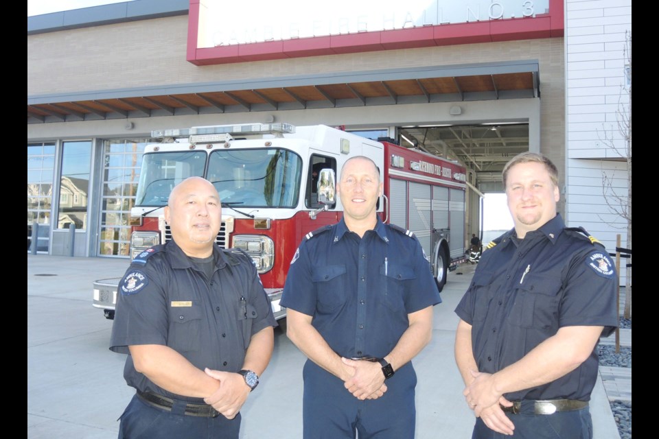 Richmond Fire-Rescue’s Brian MacLeod (centre) and BC Ambulance Station 250’s Roger Mah (left) and Chris Griffiths approve of the move to house paramedics and firefighters in the new Cambie Fire Hall No. 3. Photo by Alan Campbell/Richmond News