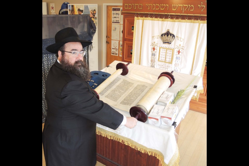 Chabad of Richmond’s Rabbi Yechiel Baitelman views the special Torah Scroll, that survived the 'Night of the Broken Glass' in Nazi Germany in 1938. The tragic events that took place were considered to be the beginning of the end for Jews in Germany. Photo by Alan Campbell/Richmond News