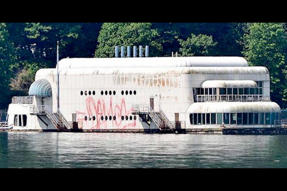 Neglected and defaced by graffiti, the McBarge sits forlornly in Burrard Inlet in 2011.