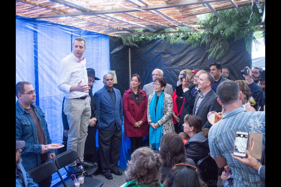 Michael Sachs (standing on chair), with the assistance from the region’s Jewish community, has doubled the size of its place of worship near No. 3 Road and Steveston Highway.