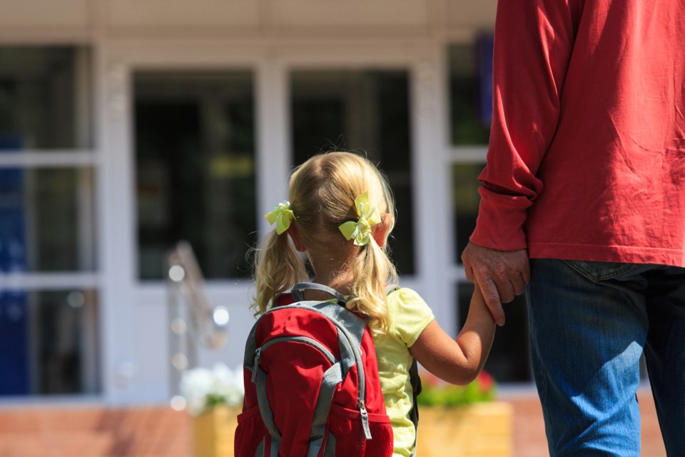 iStock, child being walked to school