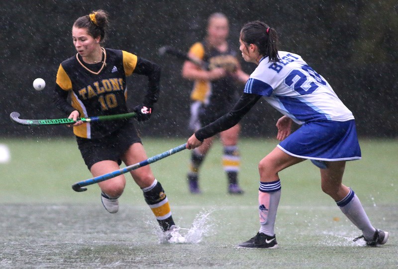 MARIO BARTEL/THE TRI-CITY NEWS
Gleneagle Talons forward Jenna Buglioni juggles the ball past Dr. Charles Best defender Georgia Lemaire in the first half of their Fraser Valley High School Girls Field Hockey Association Coquitlam zone championship, Wednesday at Best. The rain got so bad, and the field so wet the game was suspended after the first half, with the second half played on Thursday (after the Tri-City News' deadline).