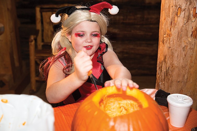 Presley Jamieson, 9, as Baby Harley Quinn carves a pumpkin at Huble Homestead on Saturday during their Halloween Spooktacular. Citizen Photo by James Doyle