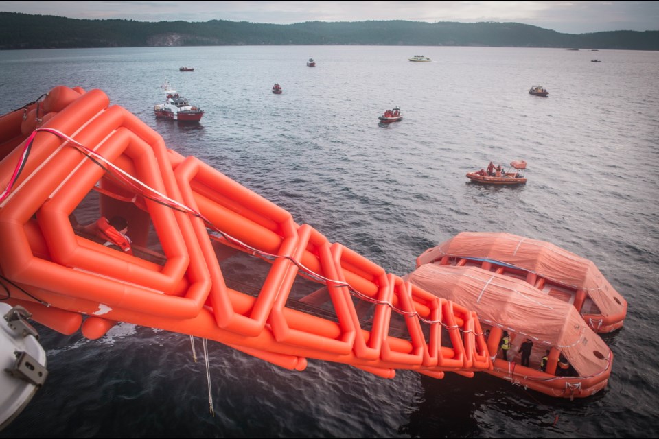 Canadian Armed Forces members stage an evacuation aboard the B.C. Ferries vessel Coastal Renaissance, deploying an inflatable slide as part of a maritime disaster exercise between Salt Spring and Galiano islands on Wednesday, Oct. 25, 2017.