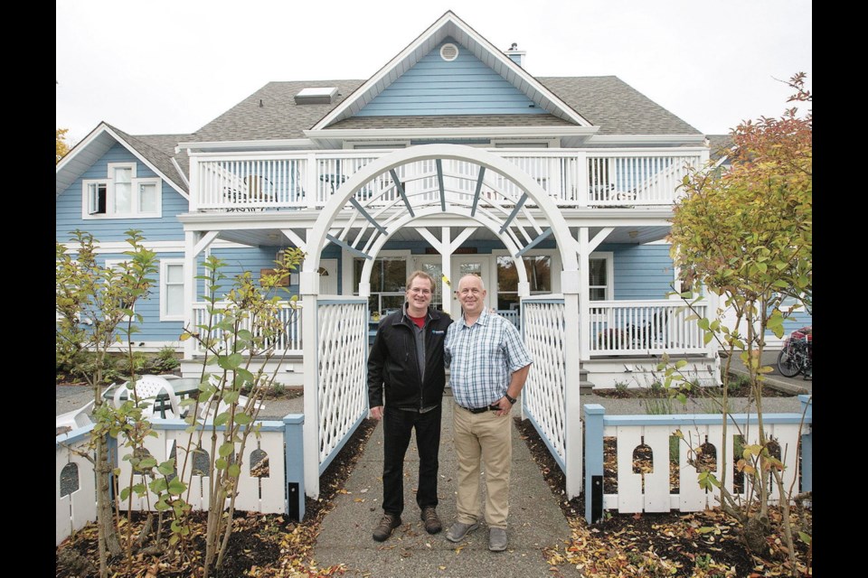 All done: HeroWork organizer Paul Latour, left, and Terry Edison-Brown at Anawim House on Caledonia Avenue. A team of volunteers has completed renovations inside and out at the facility, described on its website as a "refuge, a home, a meeting ground, and a source of hope for many of Victoria's street community."