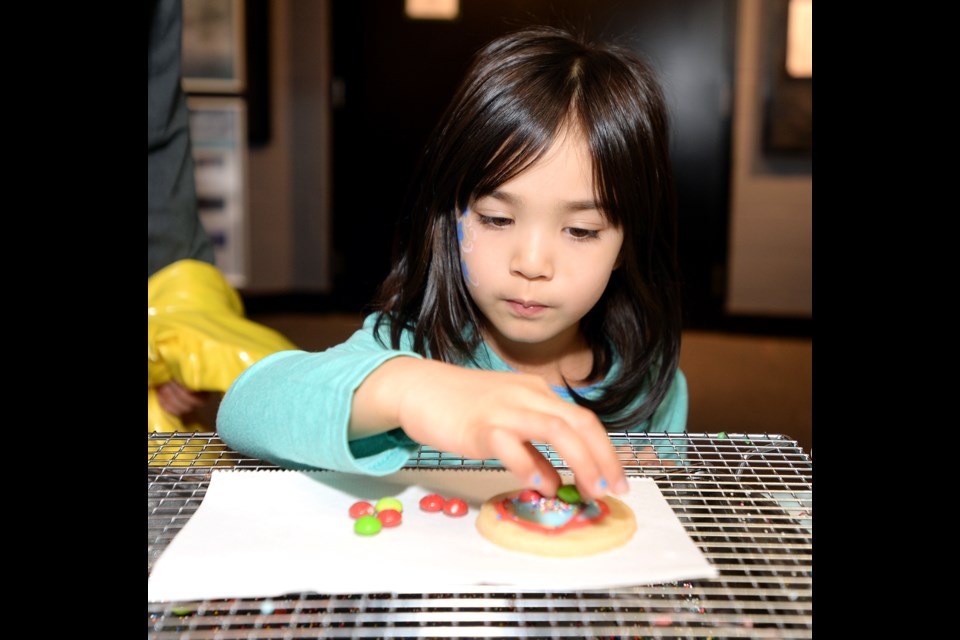 Lyric Camara, then four years old, decorates a cookie at last year's Deer Lake Craft Festival. Cookie decorating will once again be offered for the kids during this year's edition of the festival, running NOv. 24 to 27.