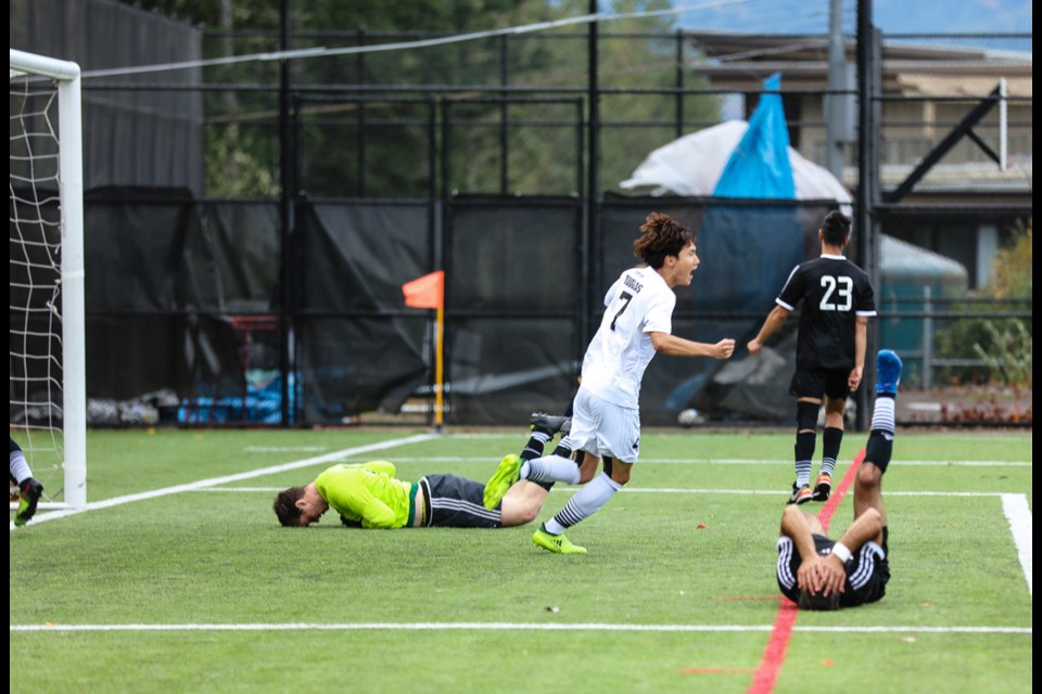 Douglas College’s David Suh, in white, celebrates the first goal of Sunday’s PacWest men’s soccer championship final, after rival Quest University surrendered an own goal. The Royals went on to claim the B.C. title with a 3-0 victory.