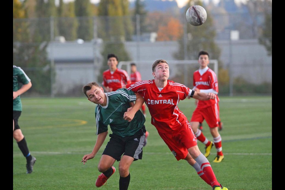 Burnaby Central co-captain Filip Rakic, at right, looks for an edge on Burnaby Mountain’s Timothy Ellen in the battle for the ball during Wednesday’s Burnaby-New West senior boys soccer league final. The Wildcats kept their unbeaten streak intact with a 3-1 victory at Burnaby Lake West.