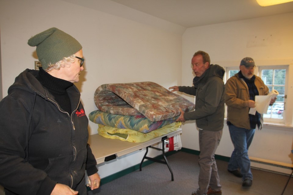 Karen Munroe, Norm Edwards and Marc Baur setting up Bowen's Emergency Shelter above the library. The entrance of the shelter is on the Cardena Rd. side of the library, beside the door to the Children's section. The rules are: no drugs or alcohol on site. Pets are welcome.