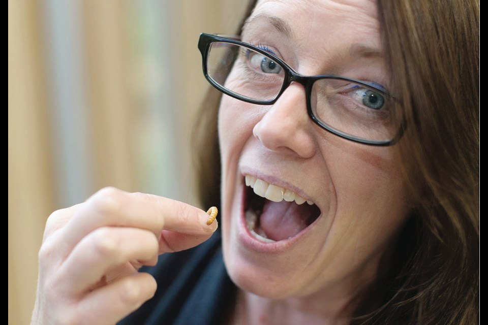 Swan Lake Christmas Hill Sanctuary executive director Kathleen Burton eats a mealworm in exchange for a $500 donation to the sanctuary.