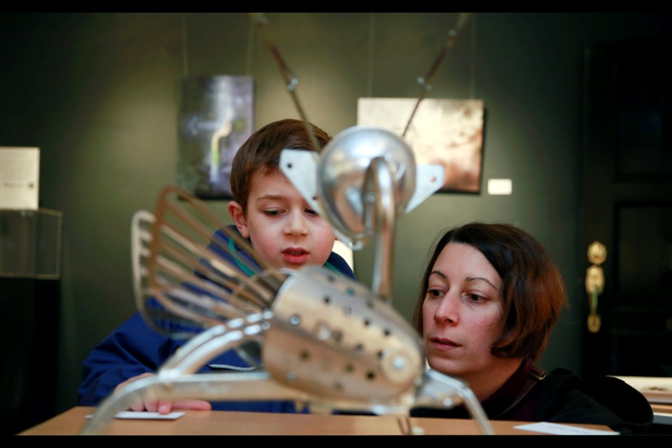 Five-year-old Simon Preston with his mom, Kristina, check out Lynne Taylor Fahnestalk’s Sentinel sculpture during the opening of the Worlds of Wonder exhibition at Deer Lake Gallery.