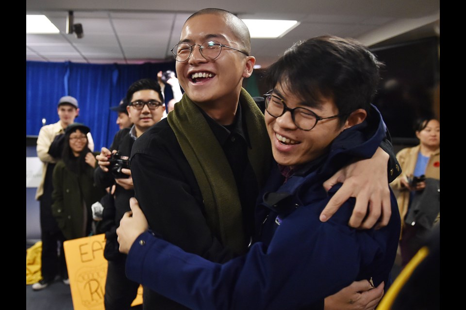 Vincent Tao and Nathanel Lowe celebrate the development permit board's 2-1 decision Monday to reject Beedie's condo proposal for Chinatown. Photo Dan Toulgoet