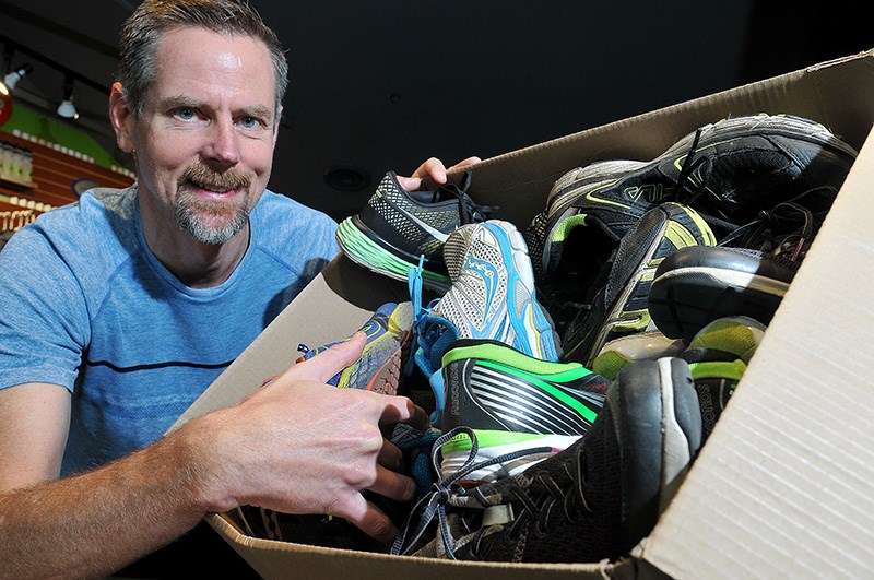 MARIO BARTEL/THE TRI-CITY NEWS
Paul Slaymaker, of the Runner's Den in Port Moody's Newport Village, prepares a box of used shoes donated by his customers that will be distributed in Vancouver's Downtown Eastside. It's one of many charitable efforts his independent shop has been involved in over the 18 years he's been in business.