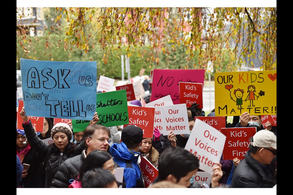 More than 200 Marpole residents held a demonstration outside Vancouver city hall Thursday to protest plans to put a modular housing complex for the homeless at West 59th and Heather Street. Two of the residents were allowed into the building to deliver a petition. Photo Dan Toulgoet