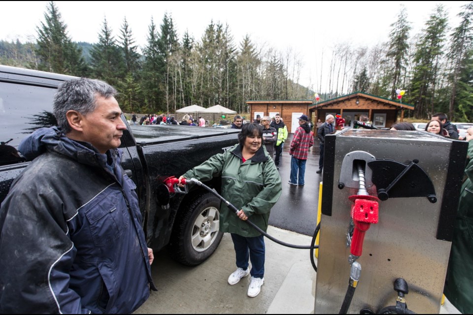 Diane Point refuels the truck of Pacheedaht Chief Jeff Jones at the opening of the Pacheedaht First Nation's gas station in Port Renfrew on Thursday, Nov. 9, 2017. For 20 years, there was no gas bar between Port Renfrew and Sooke.
