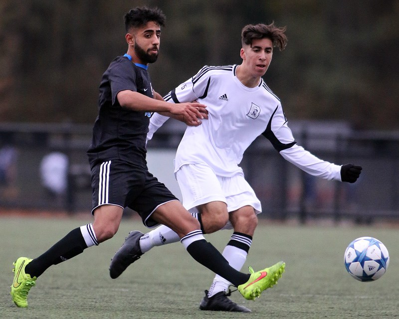MARIO BARTEL/THE TRI-CITY NEWS
Dr. Charles Best forward Daniel Jelenici and Panorama Ridge defender Sahil Dhindsa battle for the ball in the first half of their Fraser Valley boys soccer championship, Thursday at Coquitlam's Town Centre park.