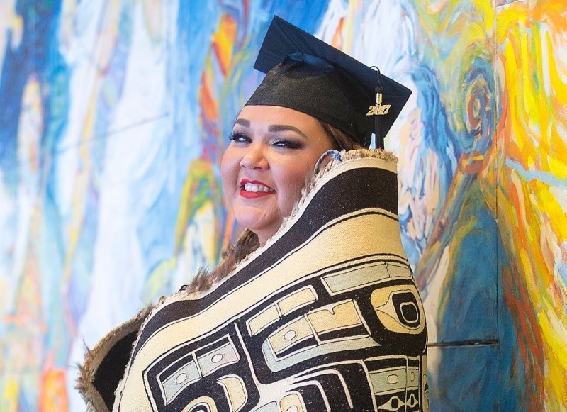 Jenny Smith, one of hundreds of graduates receiving their degrees, wears a 350-year-old Potlatch blanket during the start of Royal Roads convocation ceremony at the Royal Theatre on Thursday, Nov. 9, 2017.