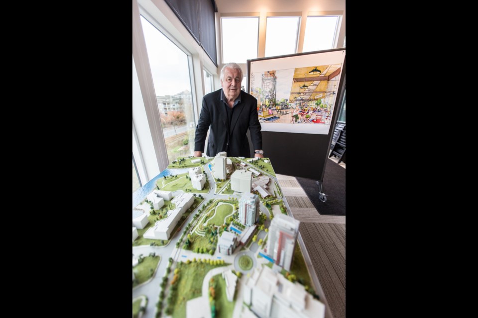 Ken Mariash in his sales centre with the model and artist renderings for the Bayview and Roundhouse developments.