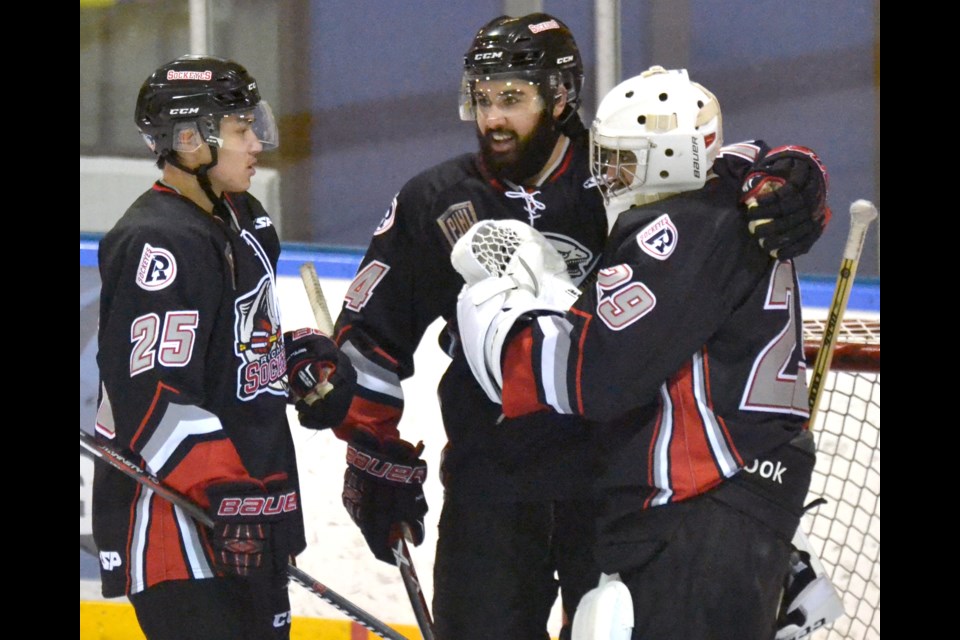 Arjun Badh and Braeden Gurney congratulate goalie Hardy Hoonjan on his shutout performance in Tuesday's 3-0 road win over the PJHL-leading Delta Ice Hawks. The result evens the season-long Tunnel Cup series between the two rivals at 1-1.