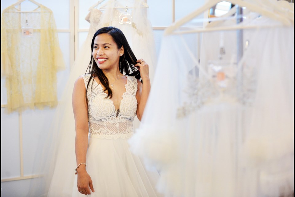 Claire Telan tries on a wedding dress at the Luxx Nova booth. The Vancouver-based online wedding dress retailer was one of more than 40 vendors that took part in the fifth annual Burnaby wedding show and swap on Sunday, Nov. 12.