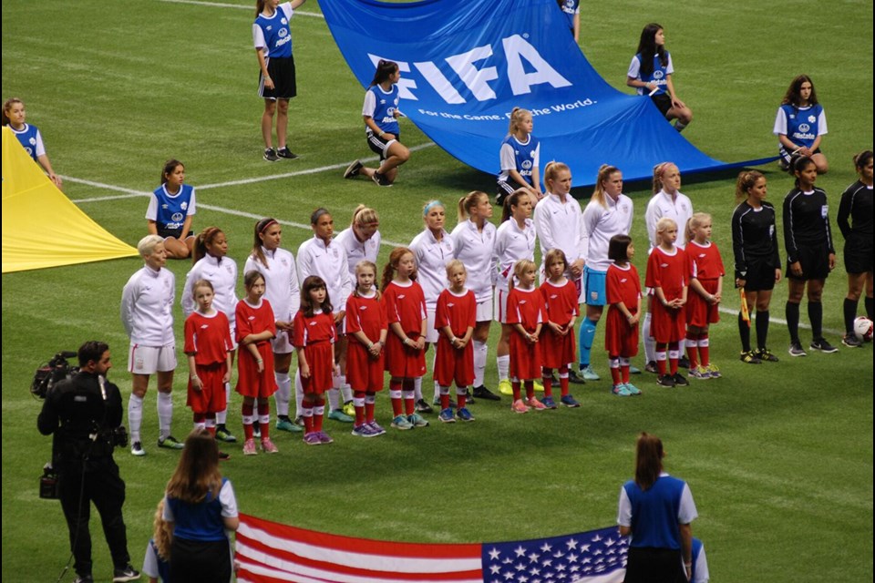 Standing for the Star Spangled Banner with members of the US National Women’s Soccer Team.