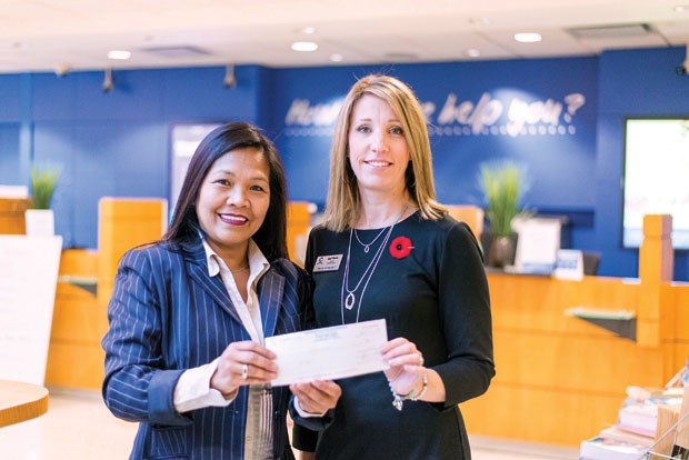 Delta Youth Support Link Society manager Josie May receives a $750 donation from Tsawwassen Coast Capital branch manager April Wiesel. The money will help enable the DYSL Society to continue their work supporting students in seven high schools across Delta.