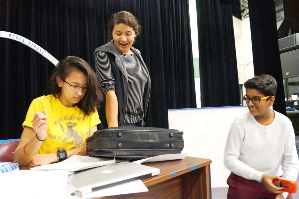 Steveston-London secondary drama students rehearse High School Confidential. Above, students Emily Ison (left), Sophie Boyd (centre) and Ved Ballary act out a scene from their characters’ home.
