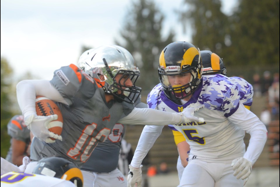 New Westminster Hyacks' Sammy Sidhu, at left, drives for another gain while Mount Douglas' Dante Carbone hopes to contain him. New West hung on to beat the visiting Rams in last Friday's quarter-final, and now play South Delta on Saturday, 5 p.m. at B.C. Place. The winner advances to the Subway Bowl AAA final.