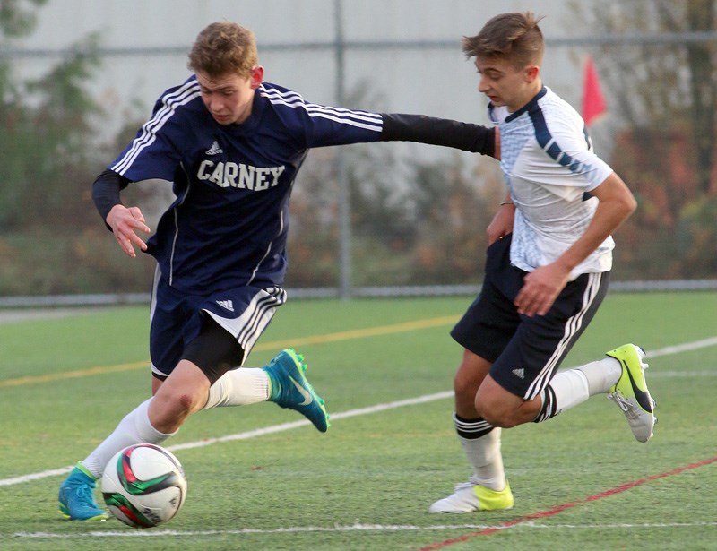 Archbishop Carney forward Dawson Brown battles a Notre Dame defender for control of the ball in the second half of their second round match in pool play at the BC Secondary Schools Soccer Commission AA provincial finals, Monday at the Burnaby Lake Sports Complex. Carney won the match 3-1 and also beat Windsor 2-1 in its first match of the day. The tournament concludes today (Wednesday). The AAA provincial finals begin Thursday, also at Burnaby Lake. Dr. Charles Best secondary, which finished second in the Fraser Valley championships, will play Kitsilano, Mount Baker and Sentinal in pool play. That tournament concludes on Saturday.