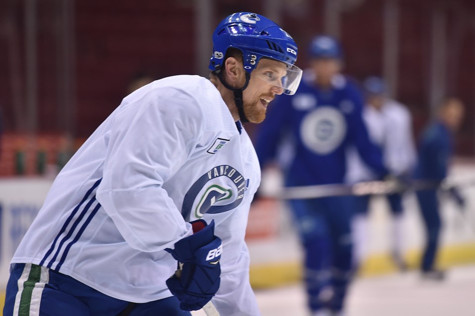 Daniel Sedin takes a pass at Canucks practice.