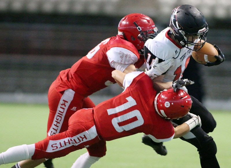 MARIO BARTEL/THE TRI-CITY NEWS
Terry Fox Ravens' running back Cade Cote is hauled down by St. Thomas More tacklers Michael Simone and Joel Pielak in their BC high school football Subway Bowl semi-final, Saturday at BC Place stadium.