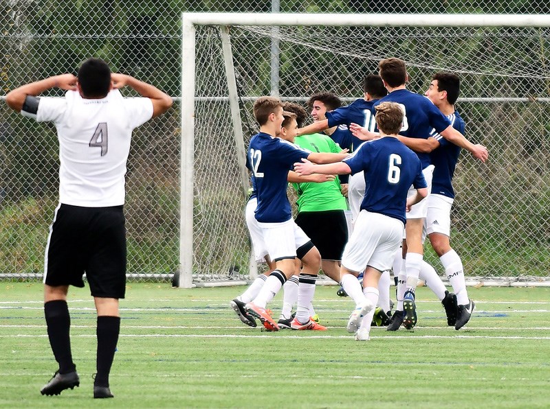 JENNIFER GAUTHIER PHOTO
The Dr. Charles Best Blue Devils celebrate their fifth senior boys' provincial soccer championship as Panorama Ridge's Ravjot Duhra walks off the pitch, Saturday at the Burnaby Lake Sports Complex. Best beat the Thunder 2-1 on a late penalty kick goal by striker Quinn Deslauniers.