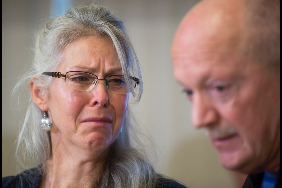 Jennifer Hedican, left cries after her husband John, right, spoke about their son Ryan Hedican, who died of a fentanyl overdose in April, during a news conference where the provincial government announced the opening of a new Overdose Emergency Response Centre at Vancouver General Hospital, in Vancouver, B.C., on Friday Dec. 1, 2017.