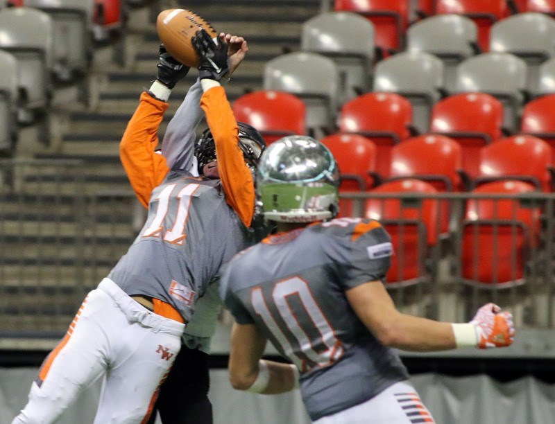 New Westminster's Severio Asaba extends in front of an opponent to catch the crucial last-second touchdown, which led to the Hyacks' two-point convert and first B.C. Subway Bowl senior football title Saturday at B.C. Place.