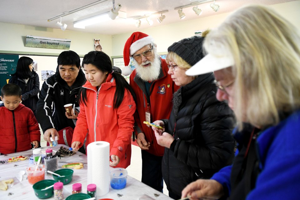 Volunteer David Stafford visits with folks who attended the Burnaby Lake Park Association's annual holiday open house on Sunday.