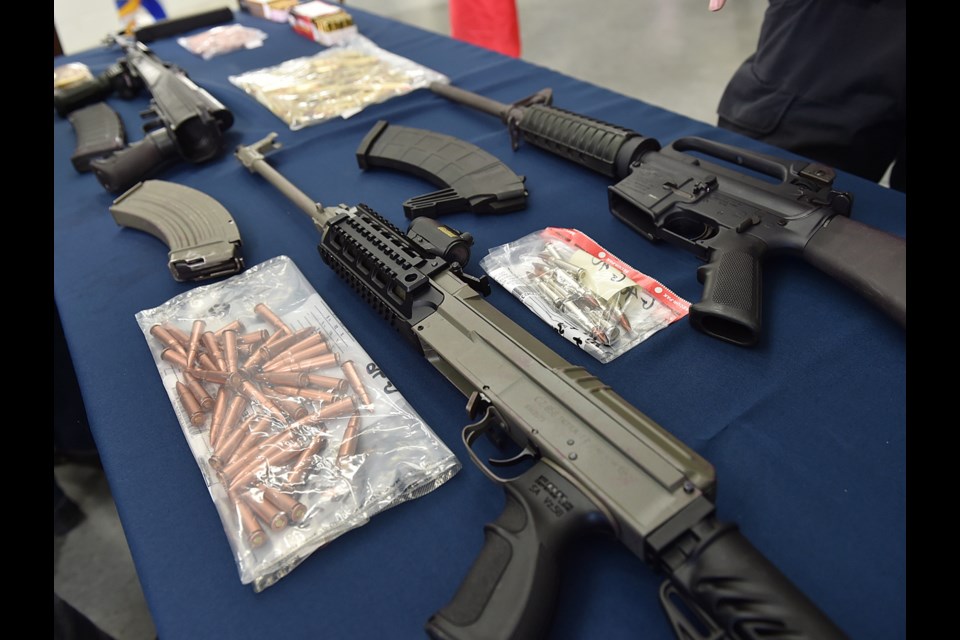 Vancouver police display some of the guns and ammunition found at a Langley farm house last month. Officers seized nine handguns, three assault rifles and more than 600 rounds of ammunition, as well as more than 500 marijuana plants and two explosive devices. Photo Dan Toulgoet
