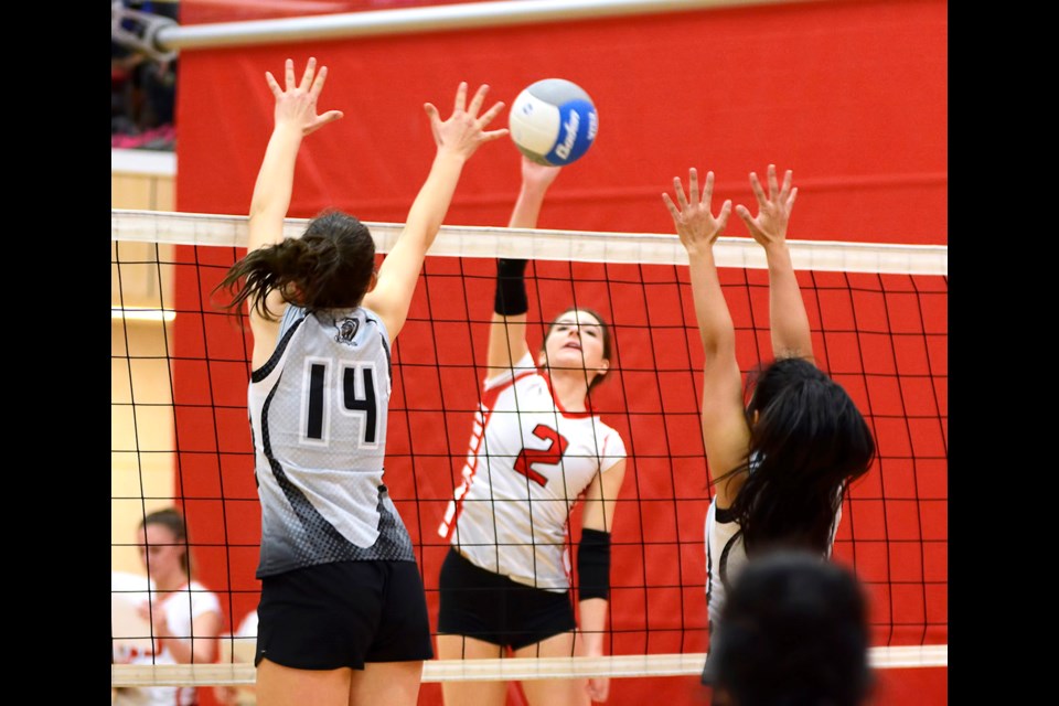 St. Thomas More’s Vanesa Gatto, in white, fires a net shot at Cambie defenders during Lower Mainland action last month. The Knights matched up against the best in B.C. and finished second last week at the AA provincials.