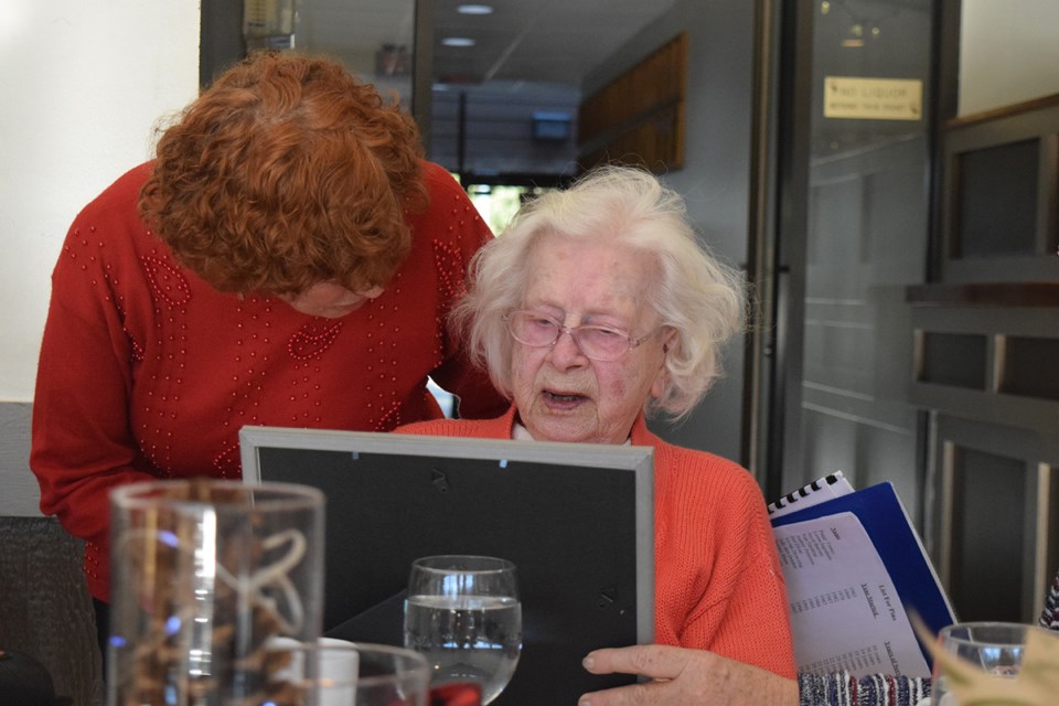 Leona Ingraham receives a certificate and pin to mark her 50 years with the auxiliary.