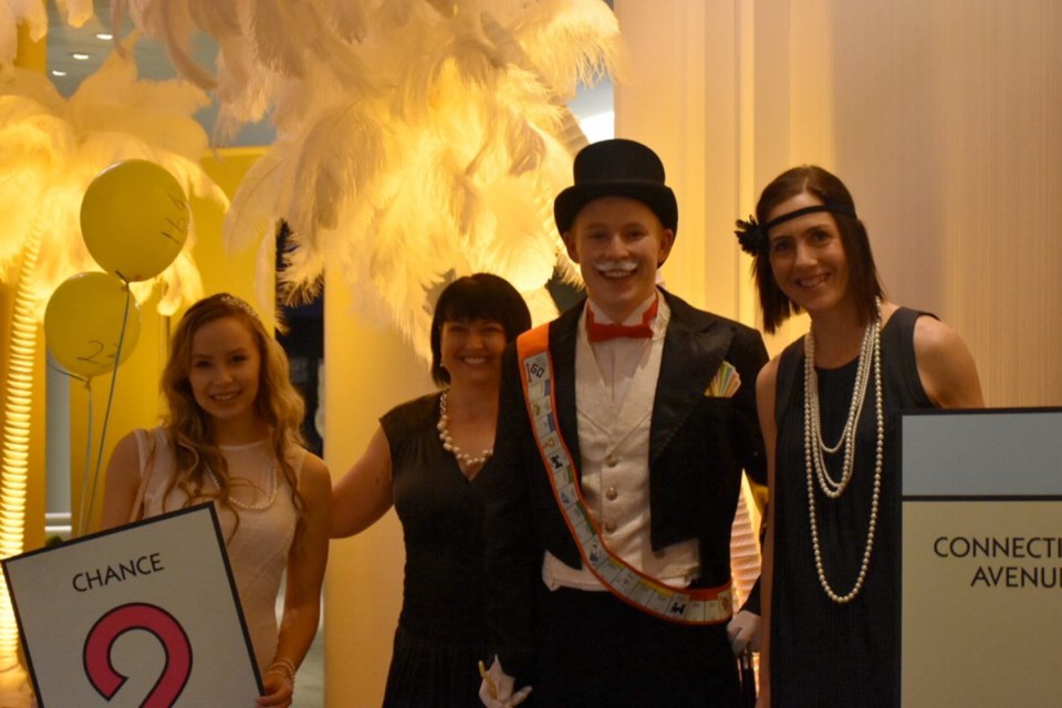 Mr. Moneybags (Chris McEachern-Law) with Monopoly Affair volunteers Stephanie Daoust, left, Tanya Chan and Kyla Beattie at a previous Monopoly Affair event. This year&Iacute;s Affair takes place Saturday at the Delta Ocean Pointe Resort and Spa.