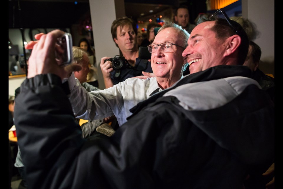 Liberal Gordie Hogg takes a selfie with a supporter during celebrations after he won the federal byelection in the riding of South Surrey-White Rock on Monday. Dec. 11, 2017.