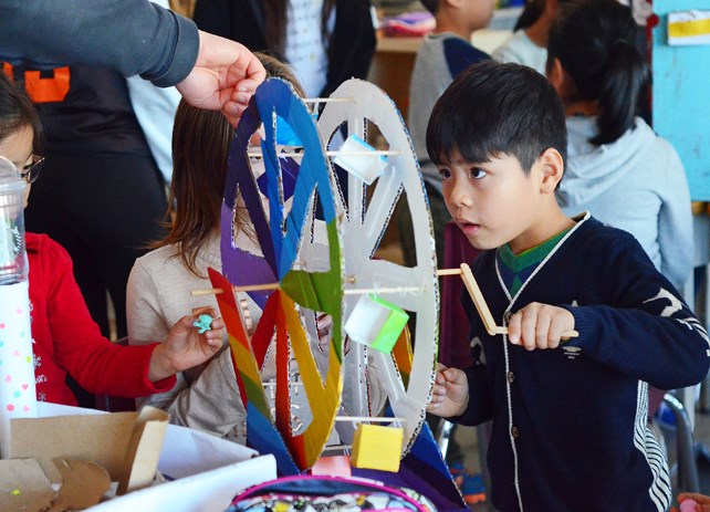 Brentwood Park kindergartner Howard Xie works a cardboard ferris wheel at his school's Great Re-Purpose Project open house last month.