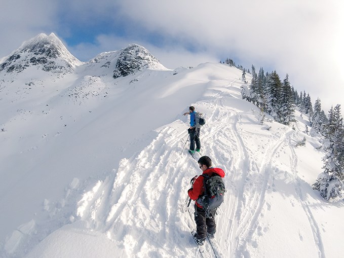 Picking a line to ski off of Disease Ridge.