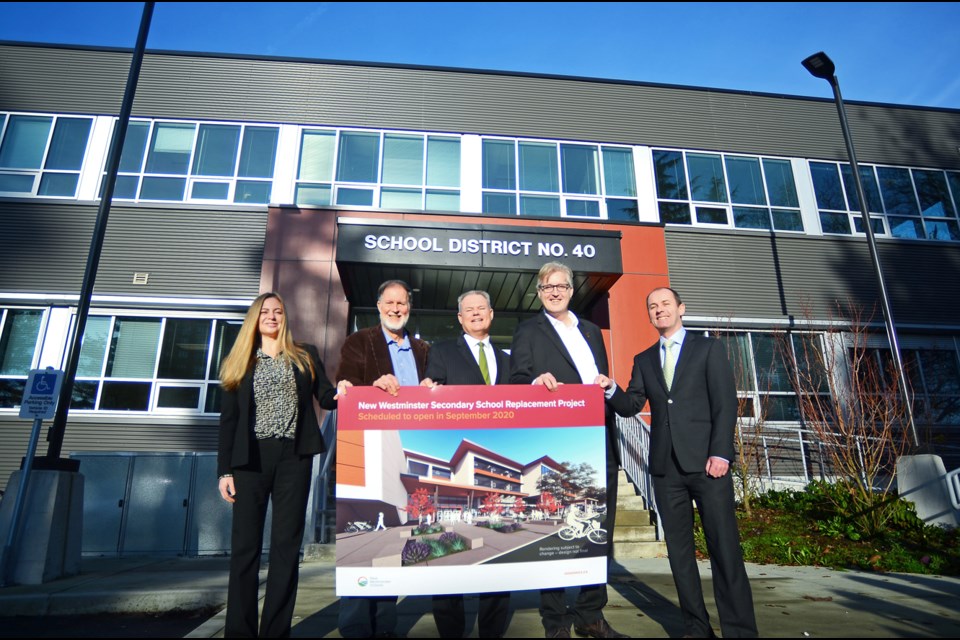 All smiles: From left, trustees Kelly Slade-Kerr and Michael Ewen, superintendent Pat Duncan, trustee and board chair Mark Gifford and Jean-Jacques Brossier of Graham Design-Builders LP. The district unveiled the first preliminary rendering of the new school at an event Wednesday. Graham Design-Builders LP and KMBR Architects Planners will lead the design-build team with an expected completion date of May 2020 with the school set to open September 2020.
