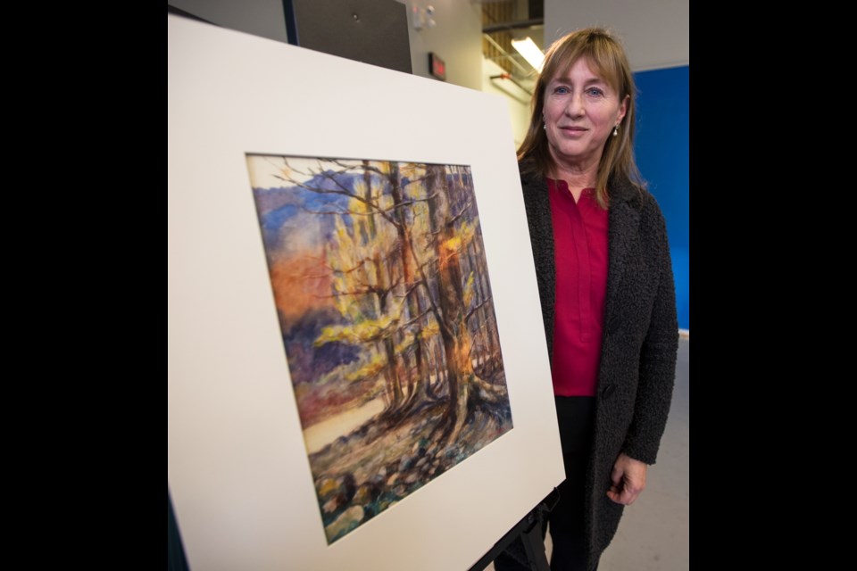 Kathryn Bridge with an Emily Carr watercolour painting at the Royal B.C. Museum on Wednesday. Dec. 13, 2017