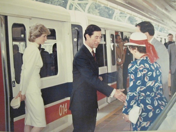 Princess Diana and Prince Charles ride the SkyTrain. Photo/The Buzzer Blog.