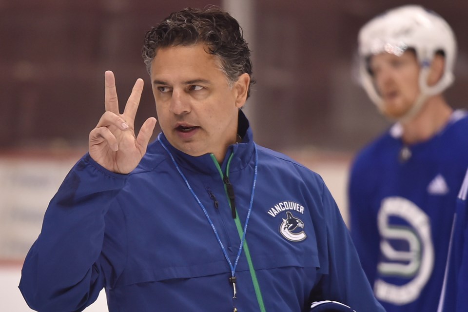 Travis Green instructs the Vancouver Canucks at practice.