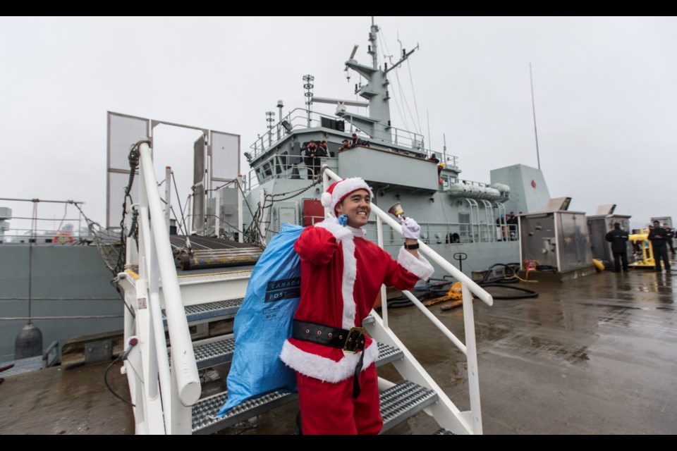 Santa Claus (a.k.a. able seaman Akira Yamagishi) is the first to depart as HMCS Nanaimo arrives at CFB Esquimalt on Friday.
