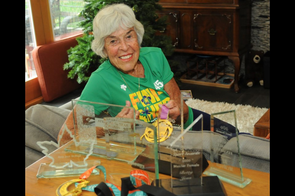 North Vancouver’s Betty Jean McHugh shows off some of her hardware, including her newest medal from the Dec. 10 Honolulu Marathon. McHugh smashed the age-group marathon world record for 90-year-olds by two hours. photo Mike Wakefield, North Shore News