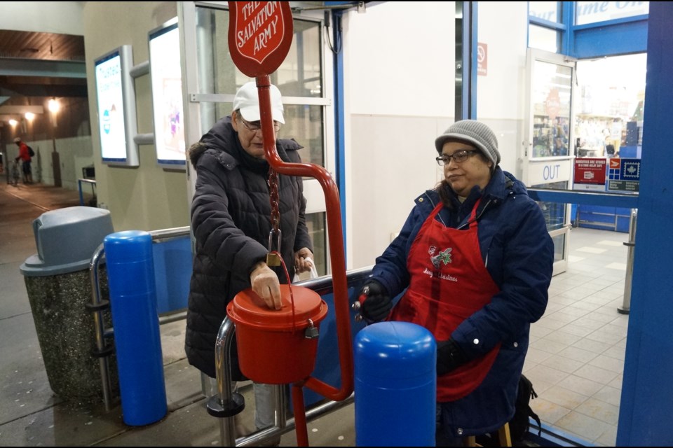 Mary Carter attends to a Salvation Army kettle at Ironwood Plaza on Dec.14, 2017.