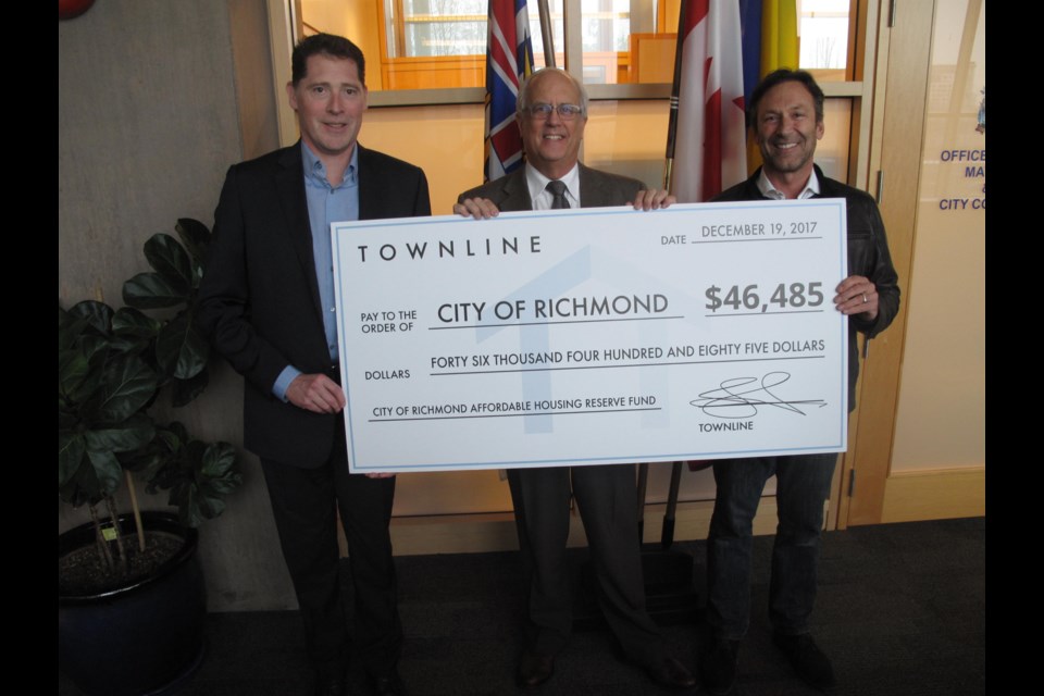 Townline Homes presented Mayor Malcolm Brodie with a cheque for over $46,000 for the City of Richmond's affordable housing reserve. The money was donated from assignment fees from Calla at the Gardens.